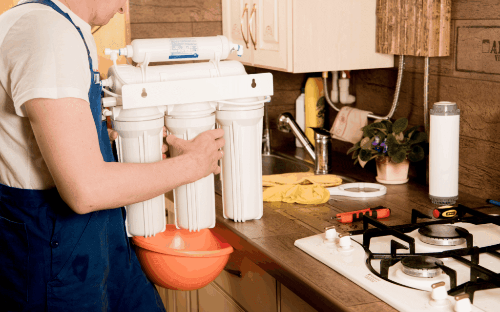 Person installing water filtration system