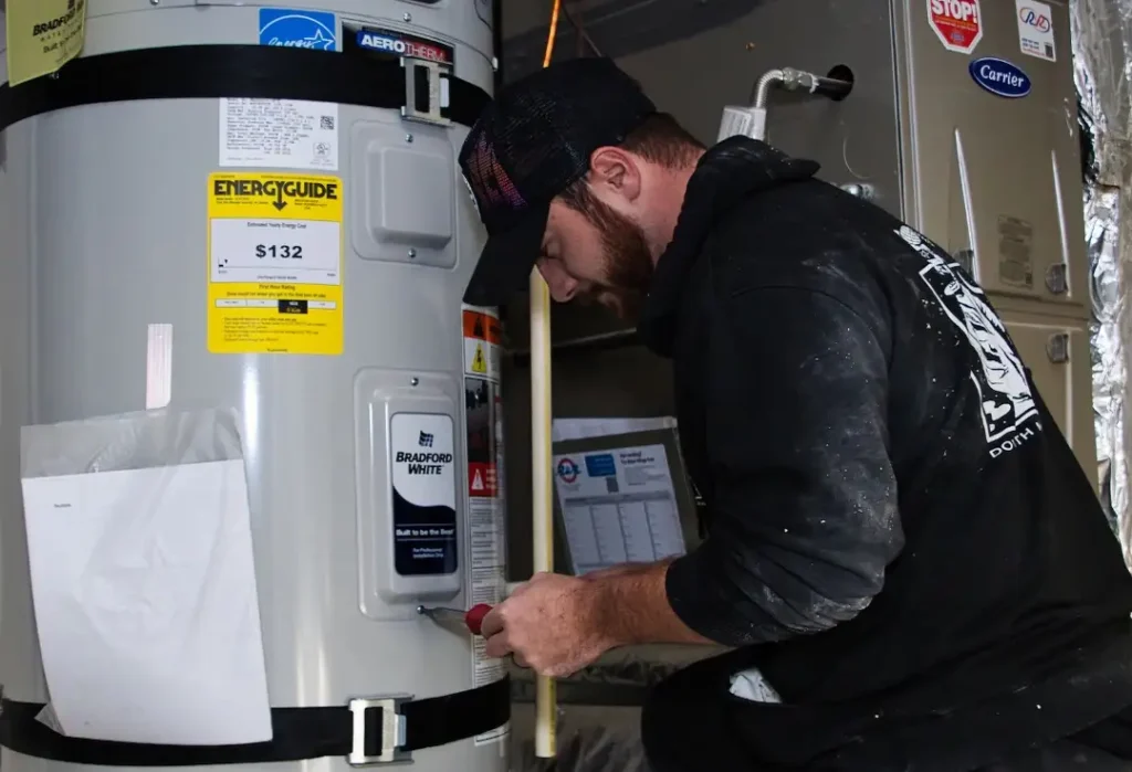 Man working on water heater installation.